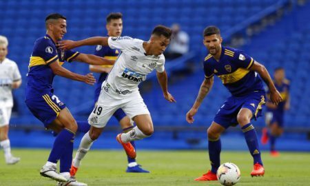 Kaio Jorge of Brazil's Santos is challenged by Lisandro Lopez of Argentina's Boca Juniors